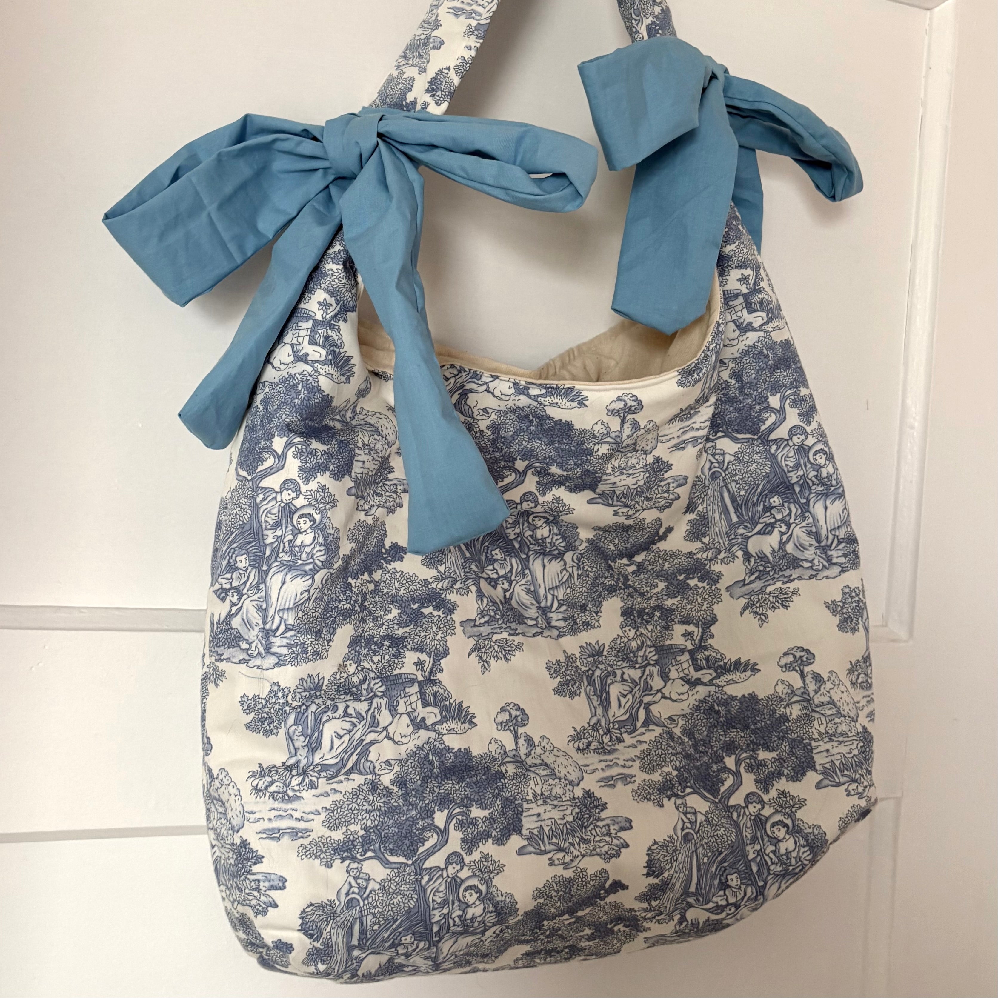Handmade white and blue porcelain coquette farm print padded tote bag with blue bows