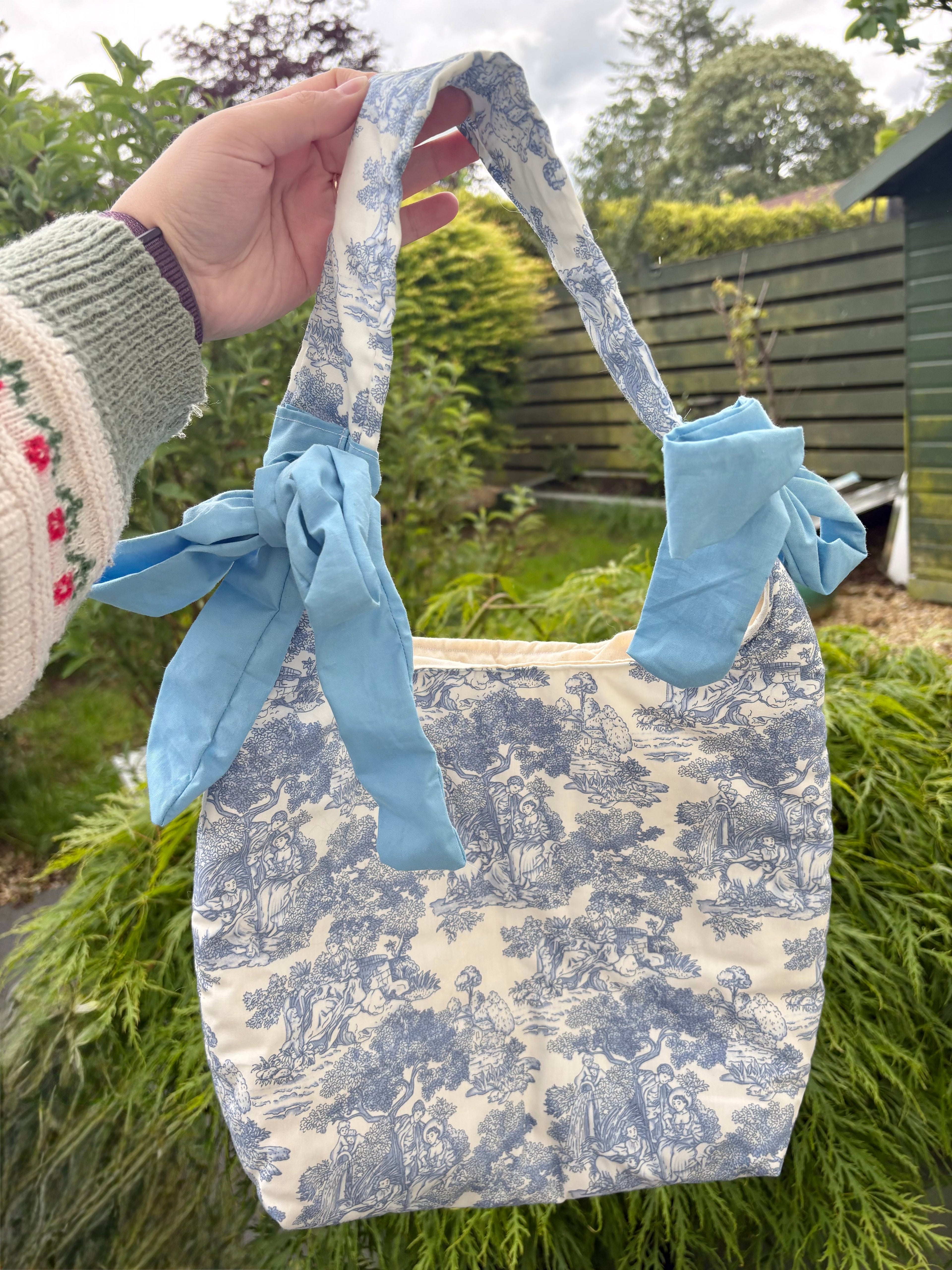 Handmade white and blue porcelain coquette farm print padded tote bag with blue bows