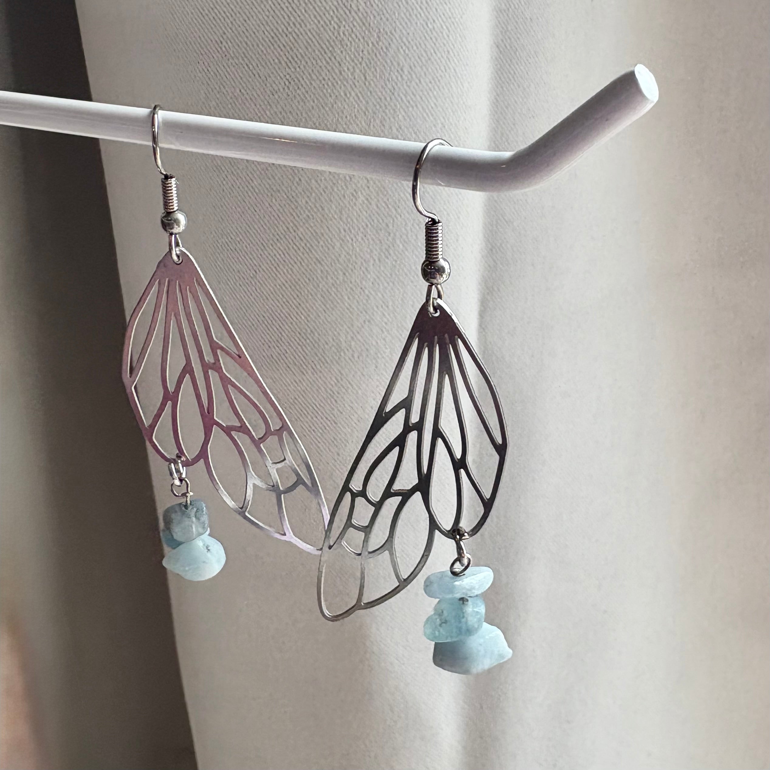 Stainless steel silver fairy wing dangle earrings with blue aquamarine crystals