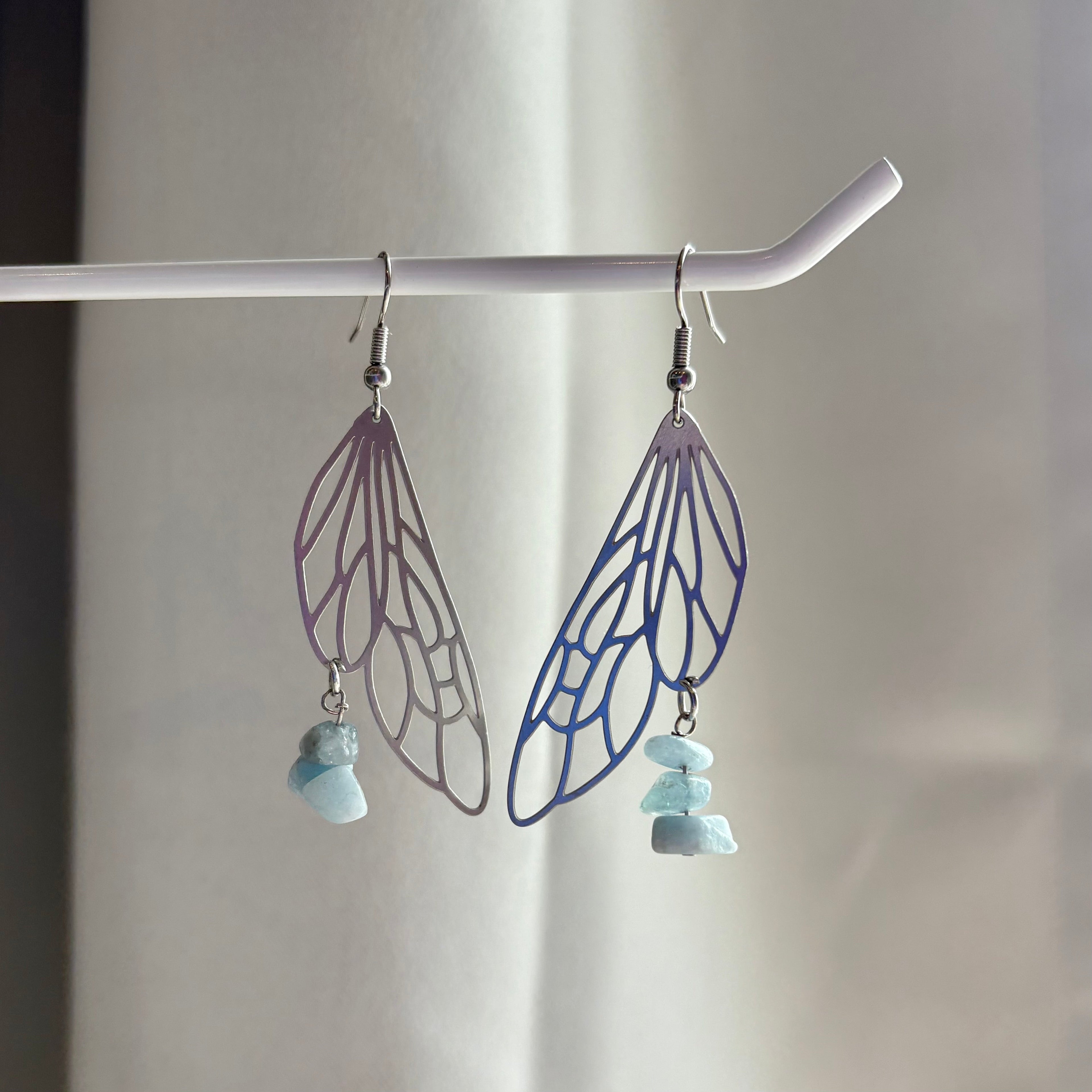 Stainless steel silver fairy wing dangle earrings with blue aquamarine crystals