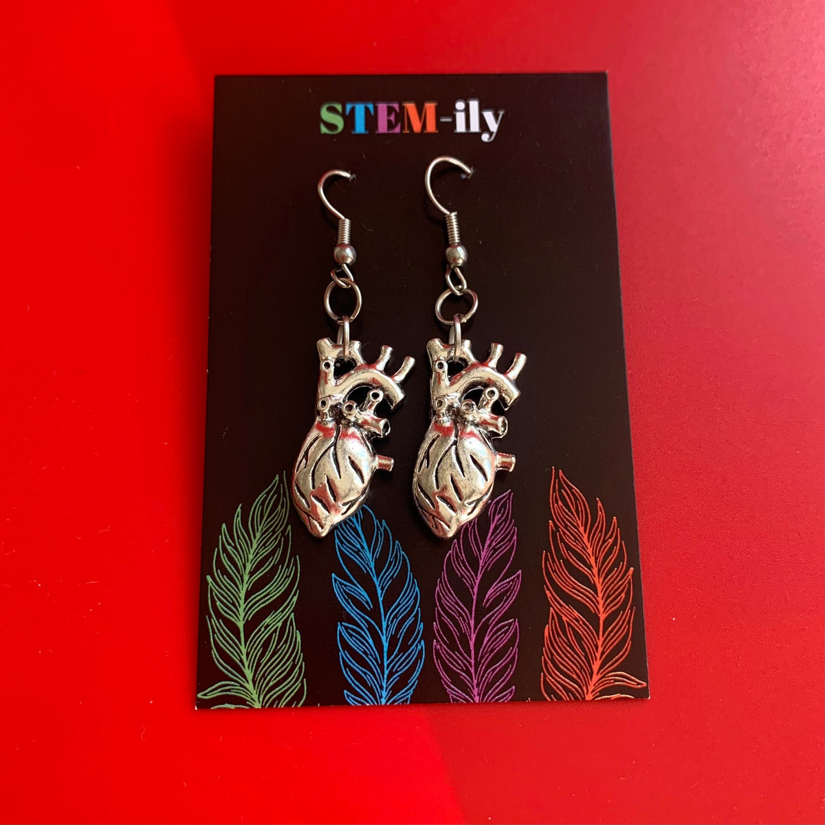 Silver anatomical heart biology dangle earrings on hypoallergenic surgical steel hooks