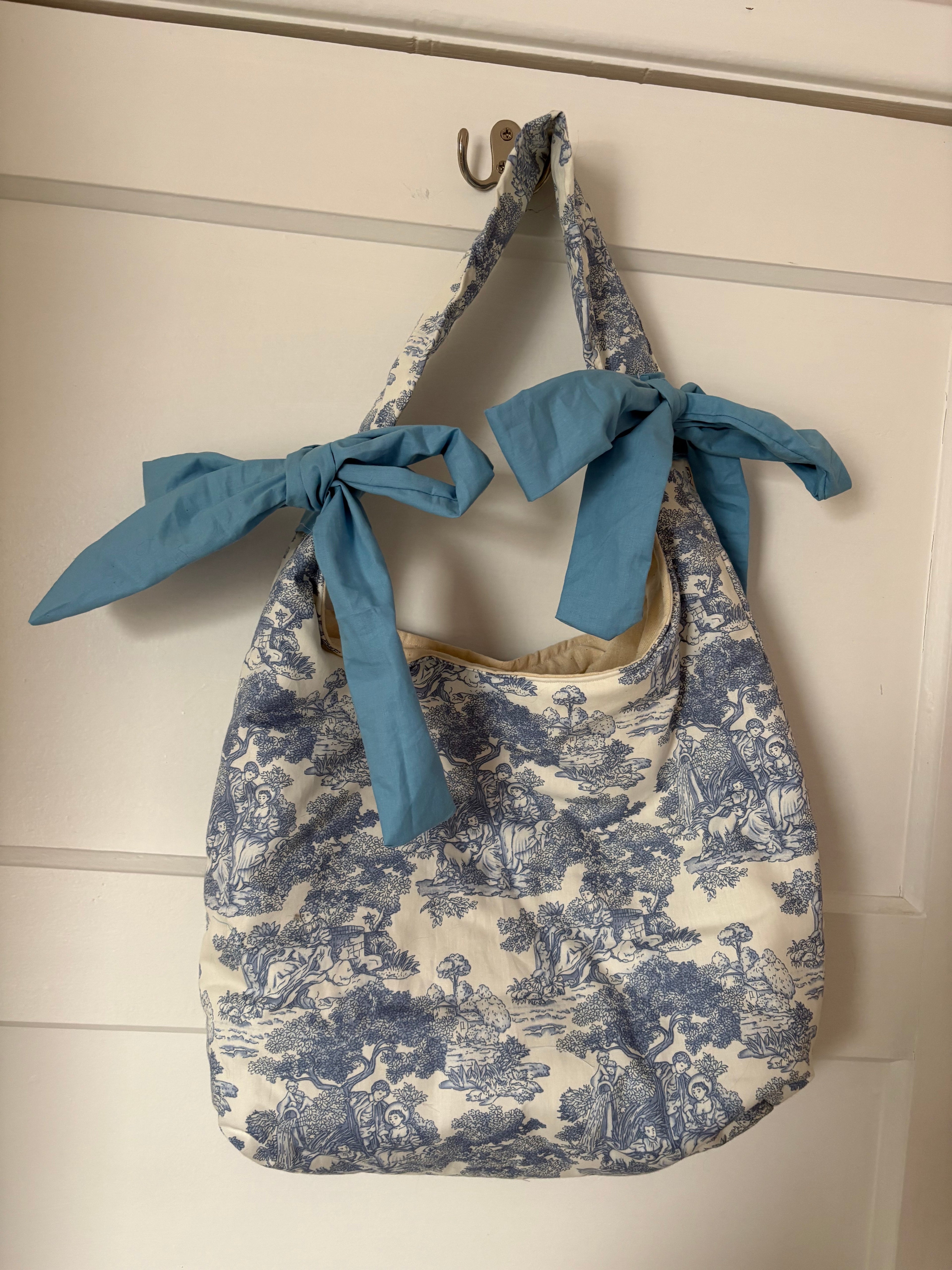 Handmade white and blue porcelain coquette farm print padded tote bag with blue bows