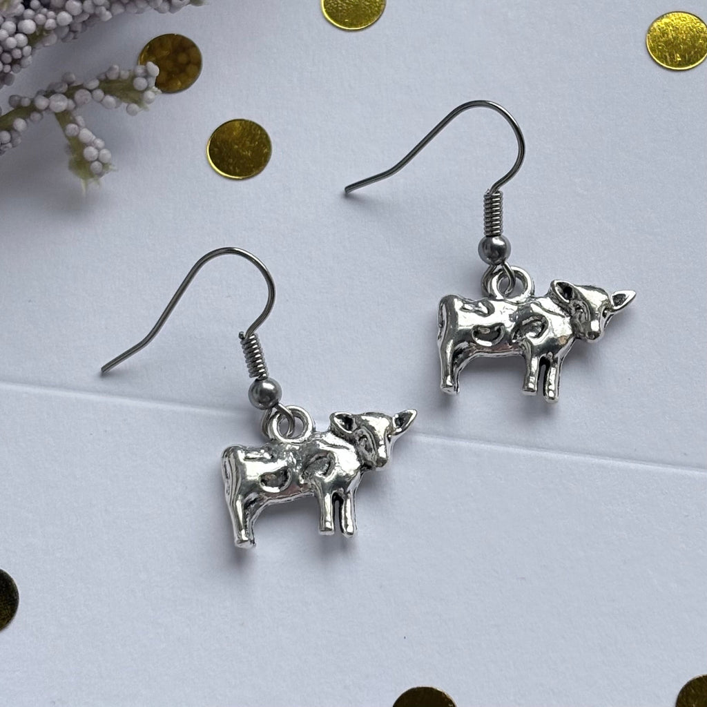 Silver cow earrings on hypoallergenic hooks