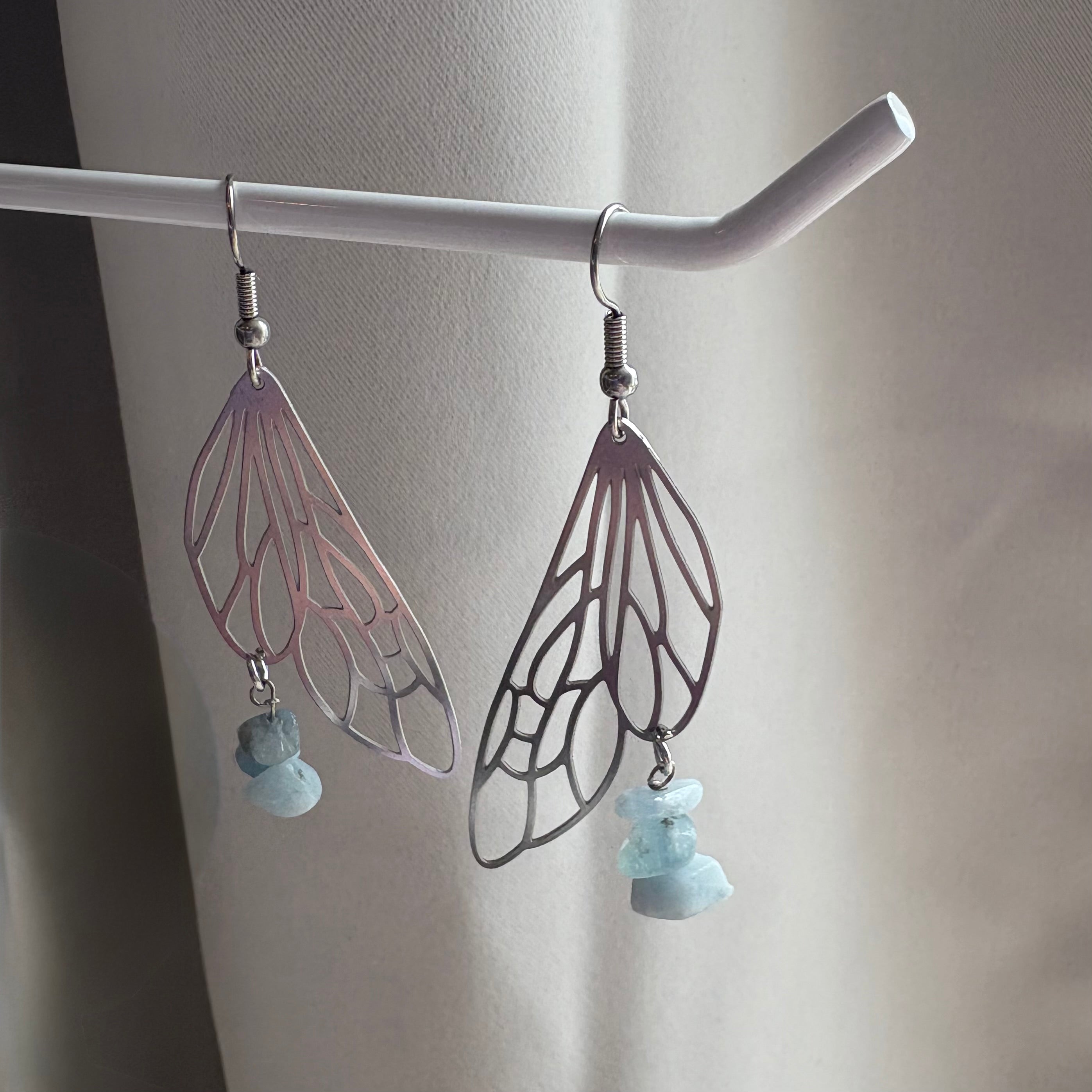 Stainless steel silver fairy wing dangle earrings with blue aquamarine crystals