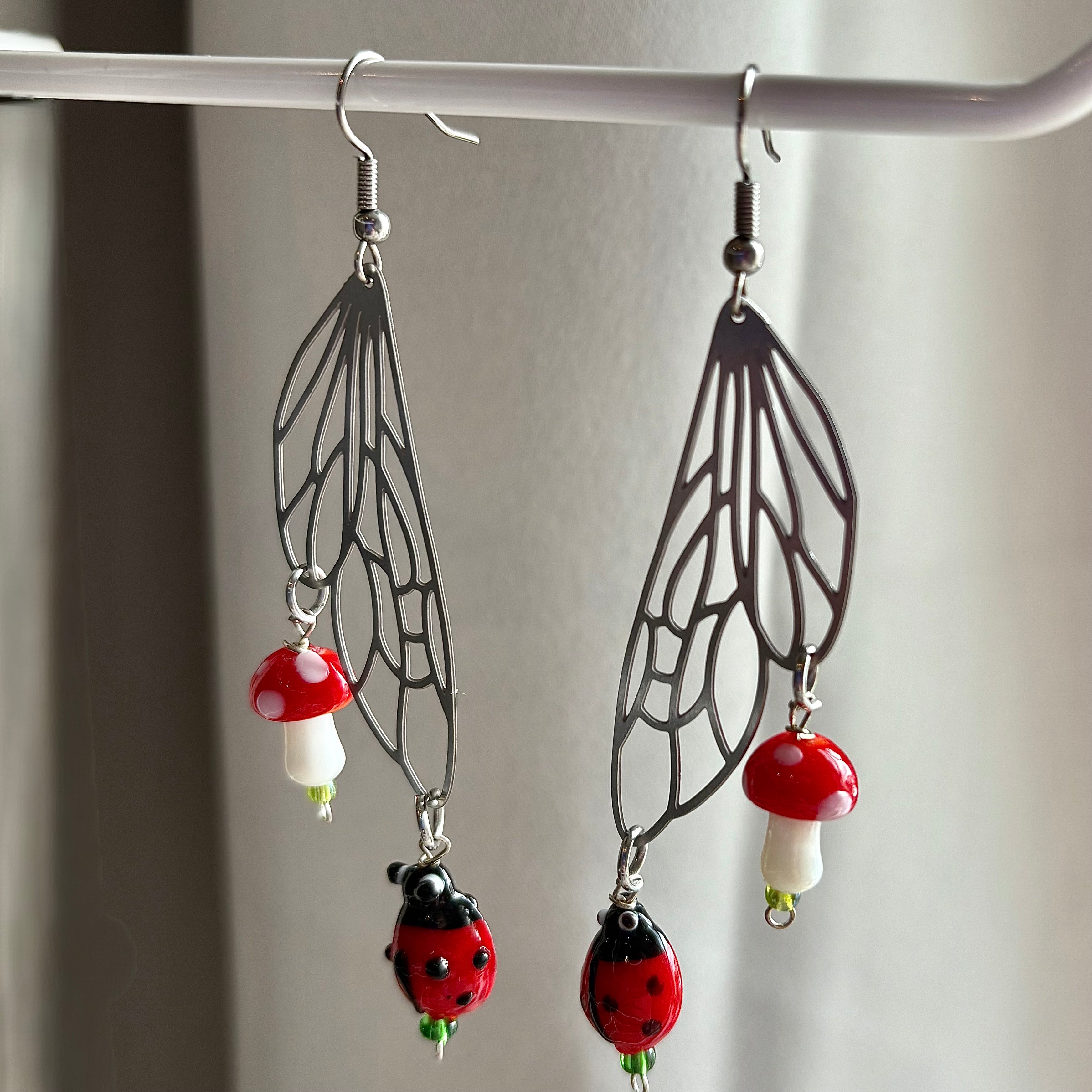 Stainless steel silver fairy wing earrings with mushrooms and ladybirds