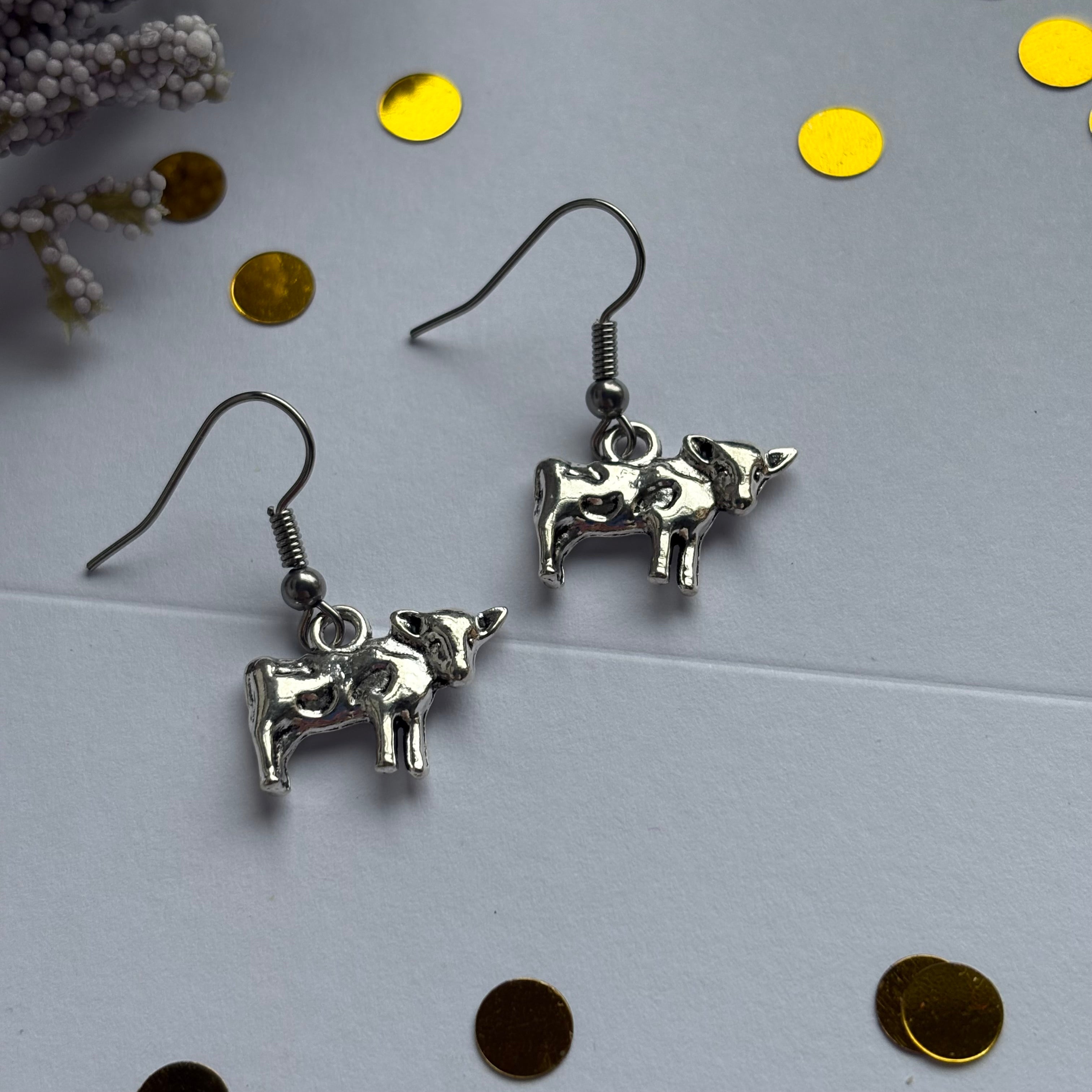 Silver cow earrings on hypoallergenic hooks