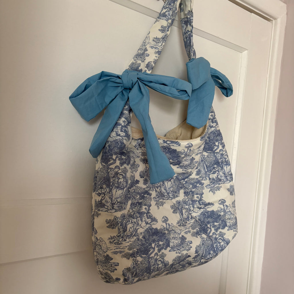 Handmade white and blue porcelain coquette farm print padded tote bag with blue bows