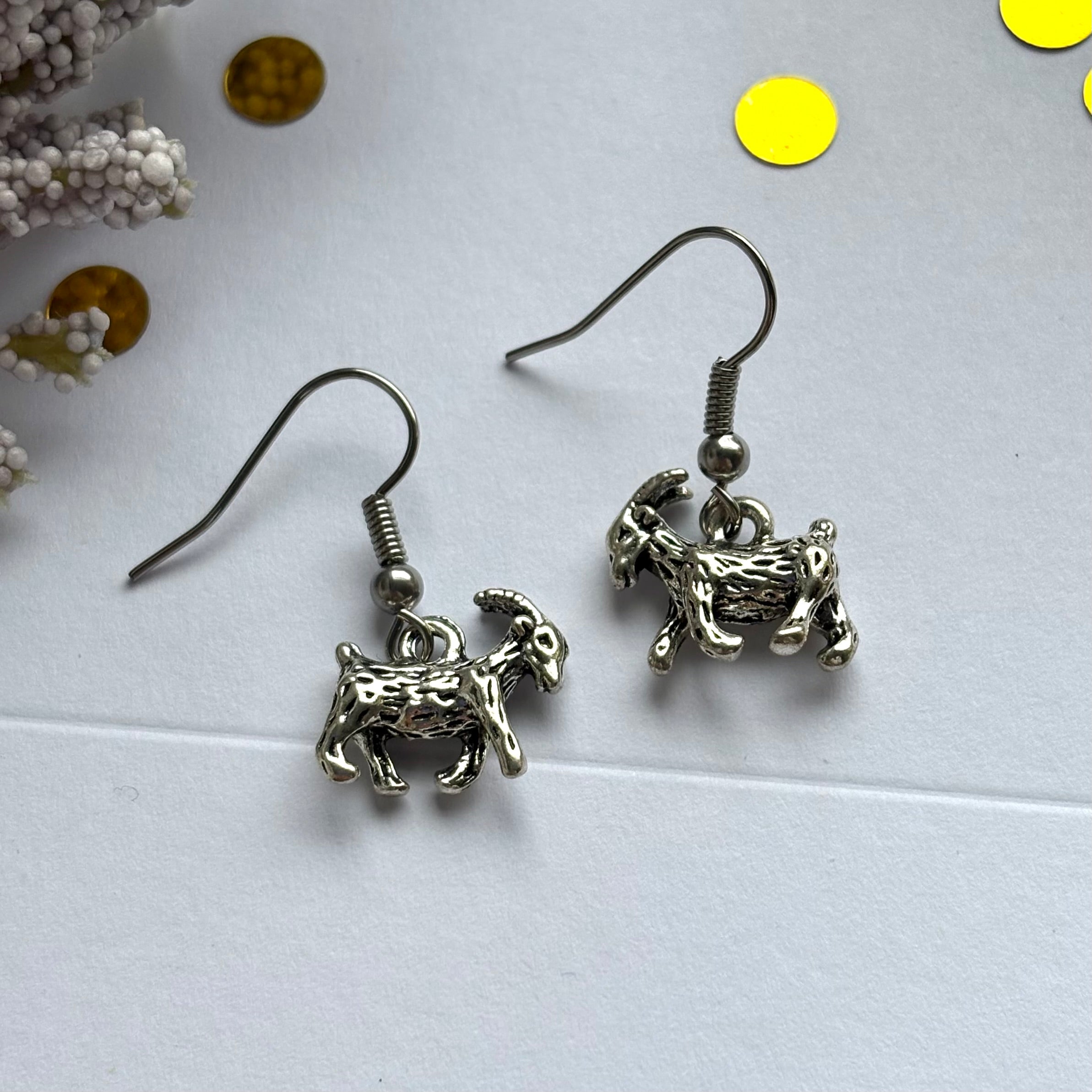 Silver goat earrings on hypoallergenic hooks