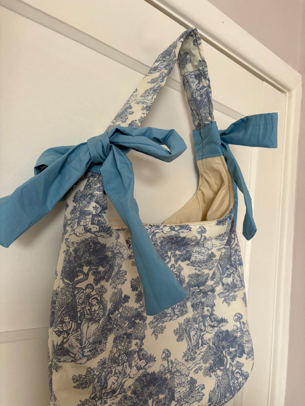 Handmade white and blue porcelain coquette farm print padded tote bag with blue bows