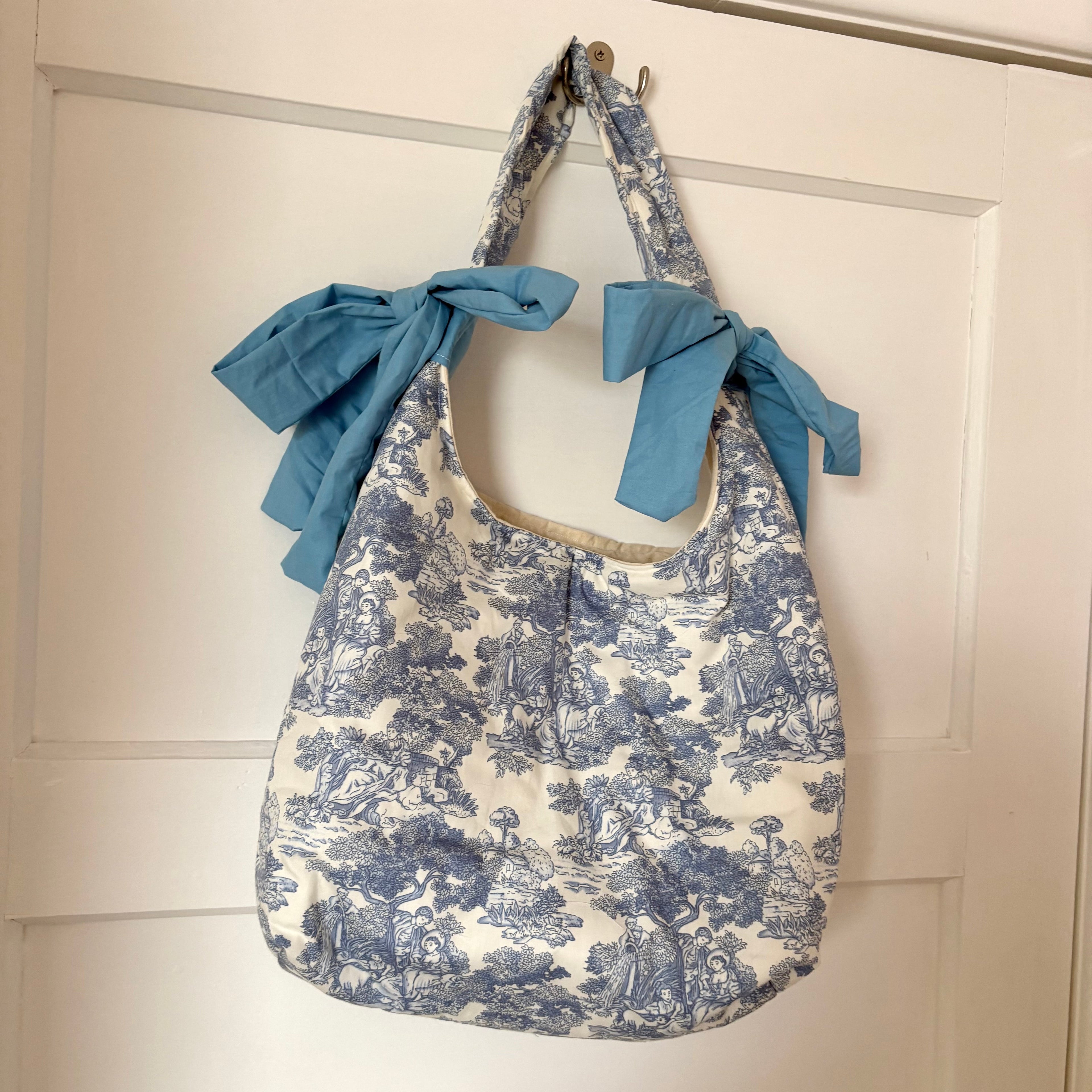 Handmade white and blue porcelain coquette farm print padded tote bag with blue bows