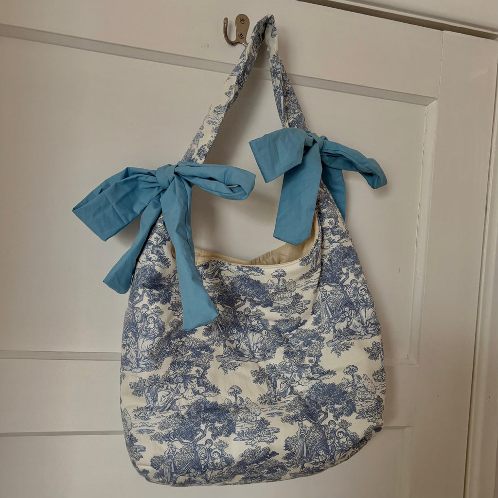 Handmade white and blue porcelain coquette farm print padded tote bag with blue bows