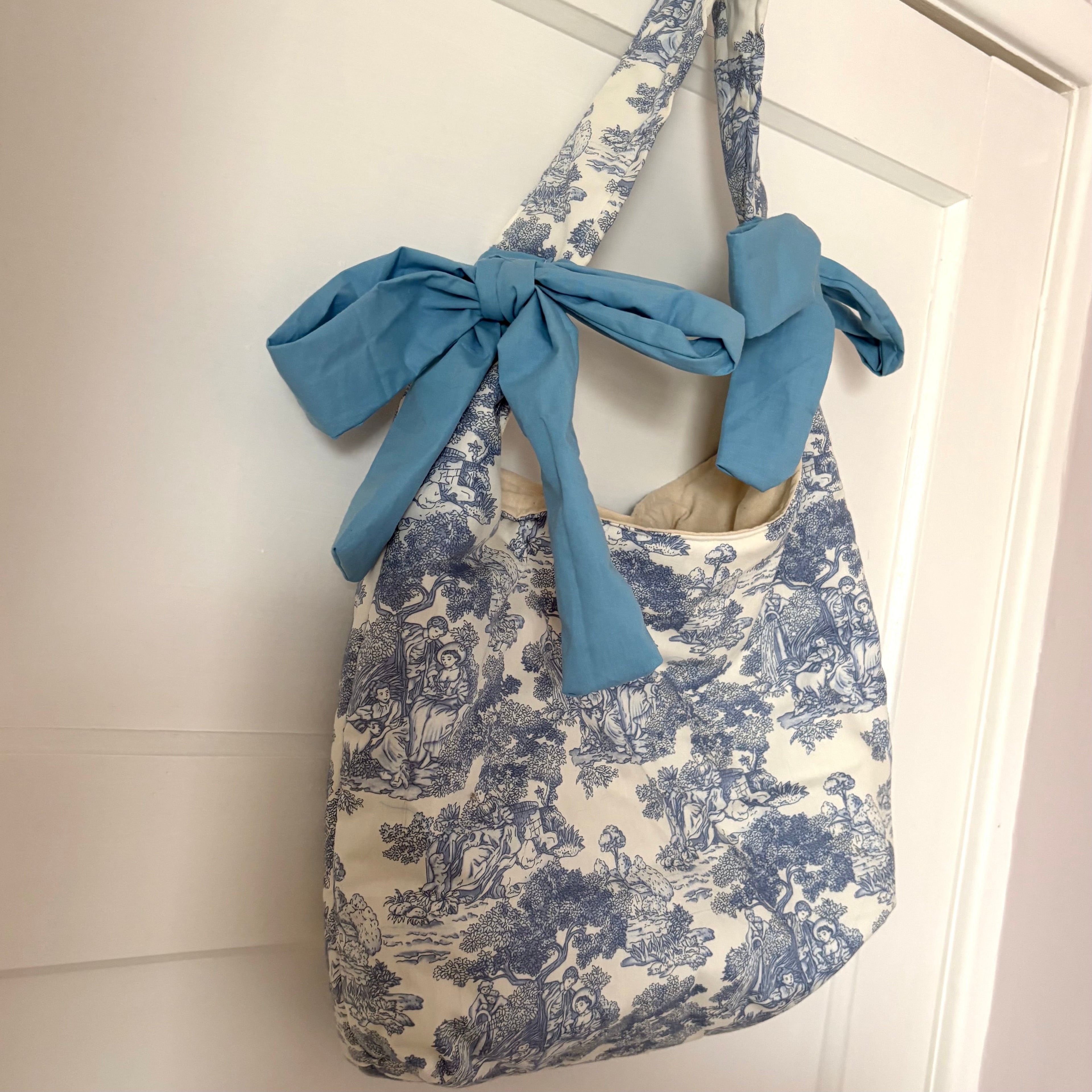 Handmade white and blue porcelain coquette farm print padded tote bag with blue bows
