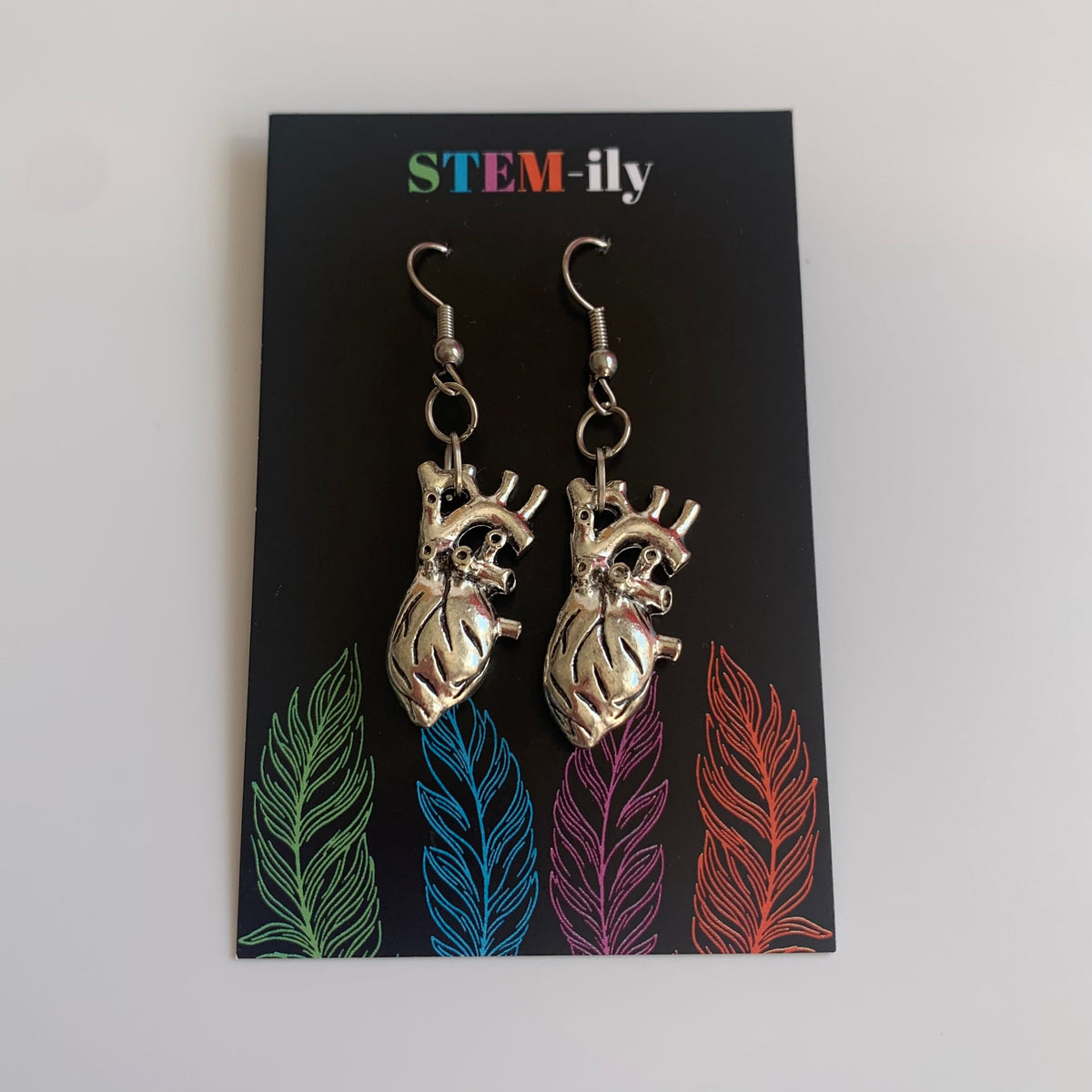 Silver anatomical heart biology dangle earrings on hypoallergenic surgical steel hooks