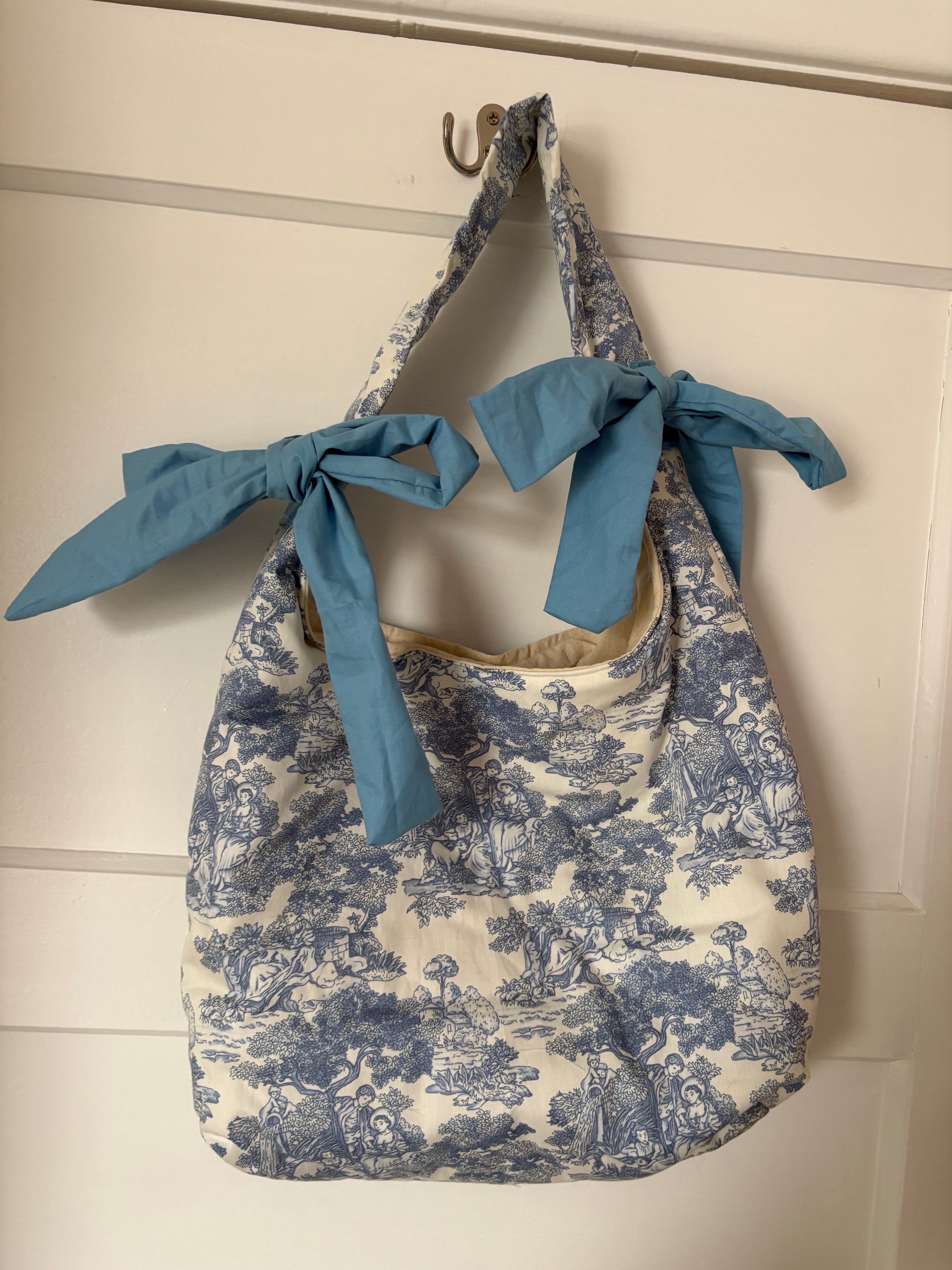 Handmade white and blue porcelain coquette farm print padded tote bag with blue bows