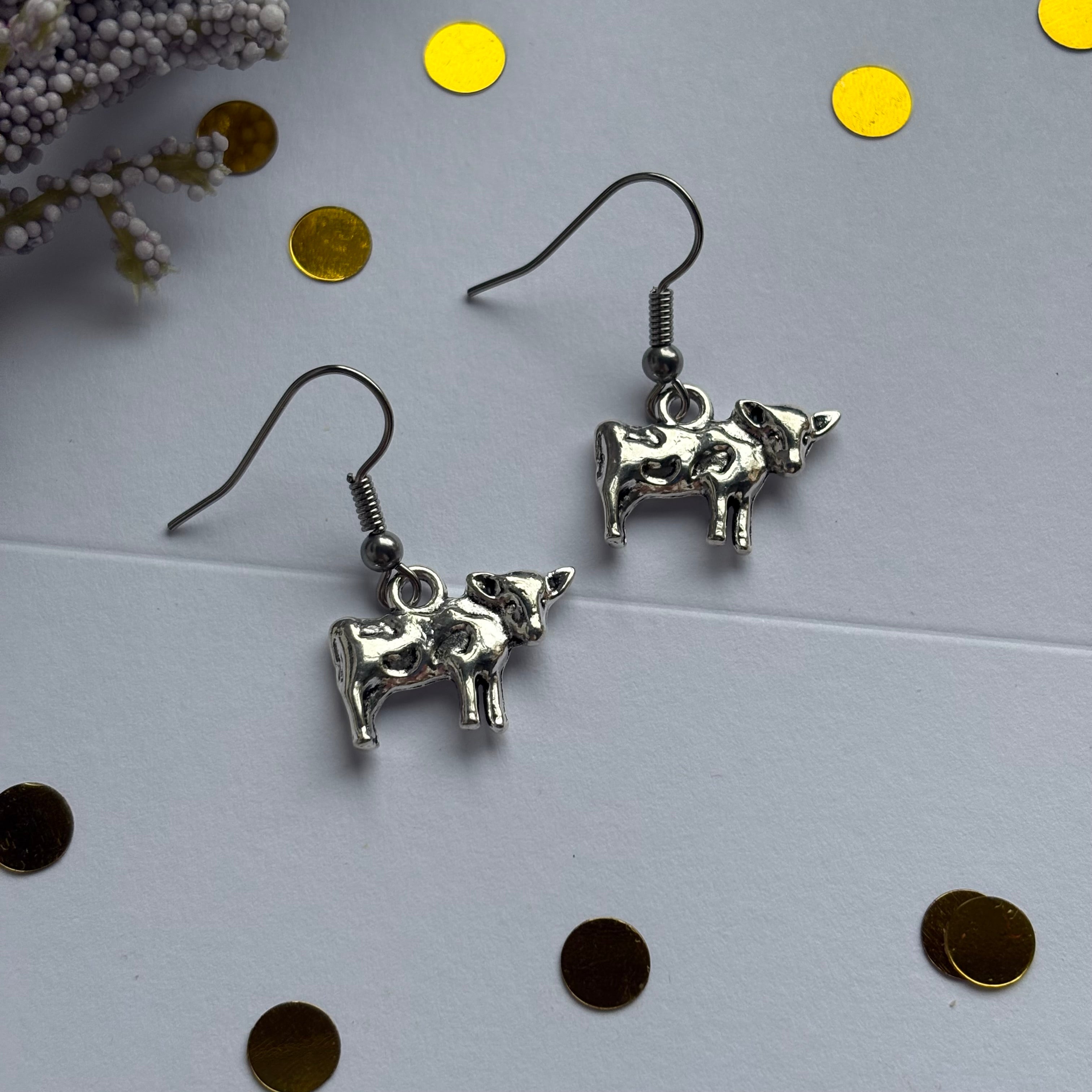 Silver cow earrings on hypoallergenic hooks
