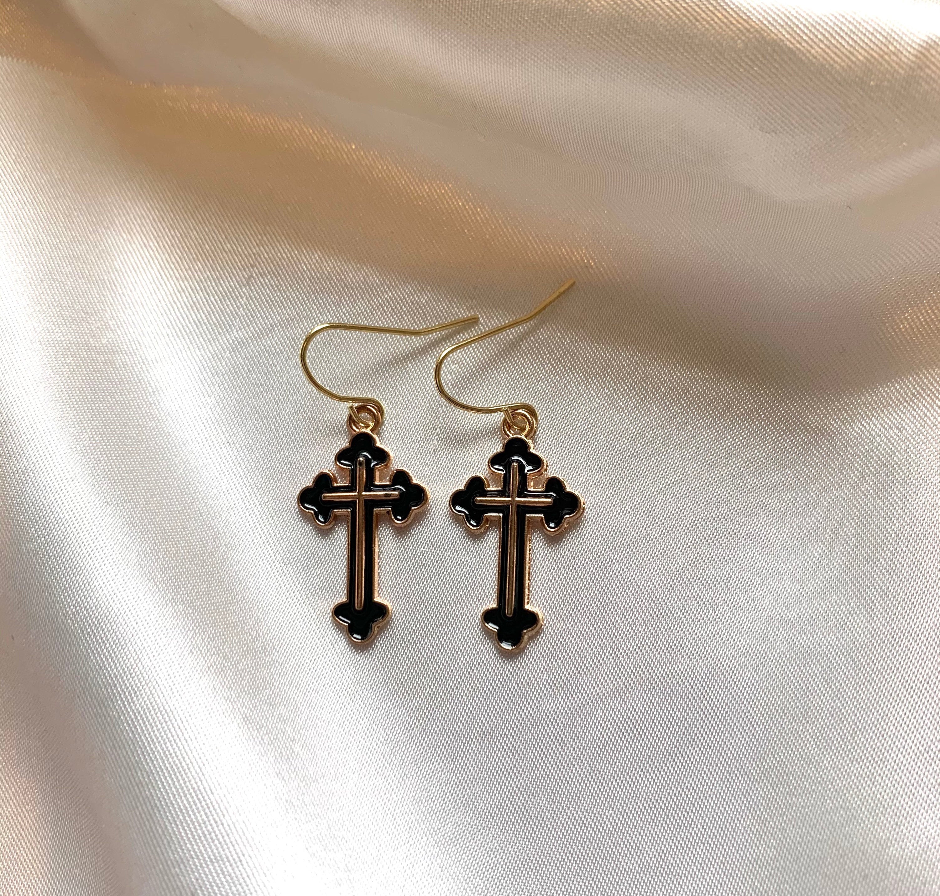 Black and gold cross dangle earrings on gold plated hooks