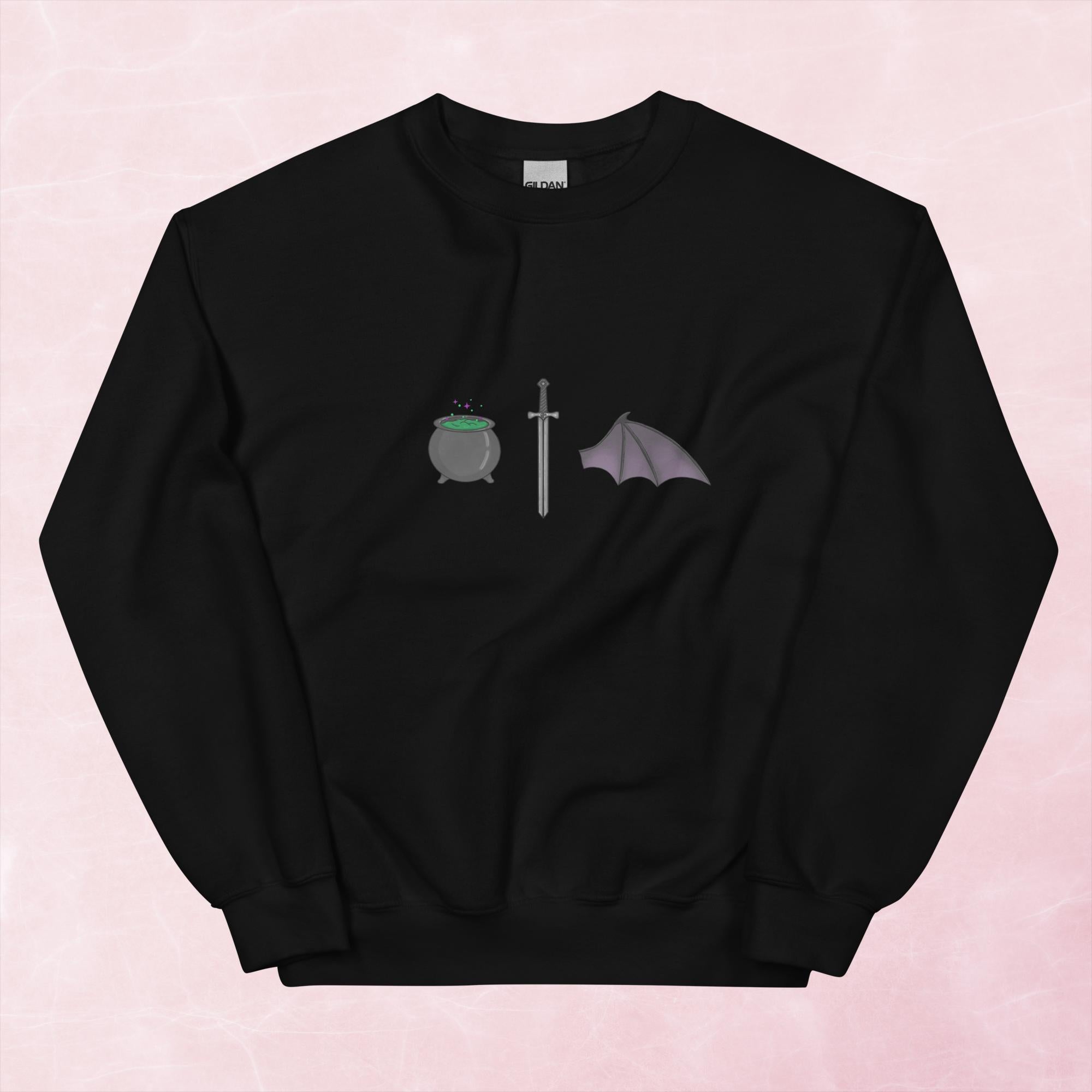 Cool hand illustrated cauldron sword and batwing fantasy book unisex graphic sweatshirt